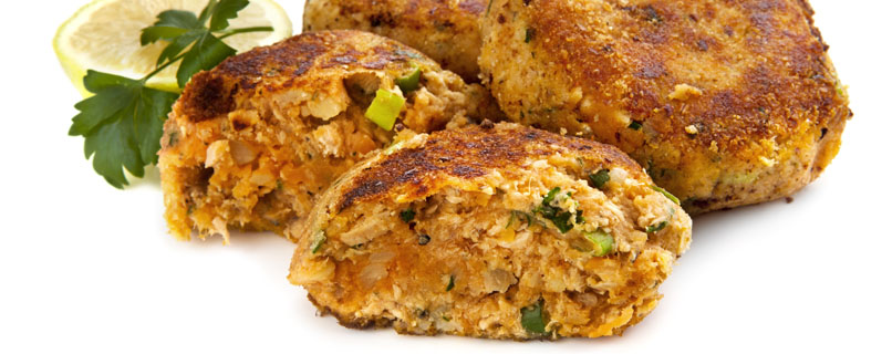 Salmon fishcakes or patties, with lemon and parsley, isolated on